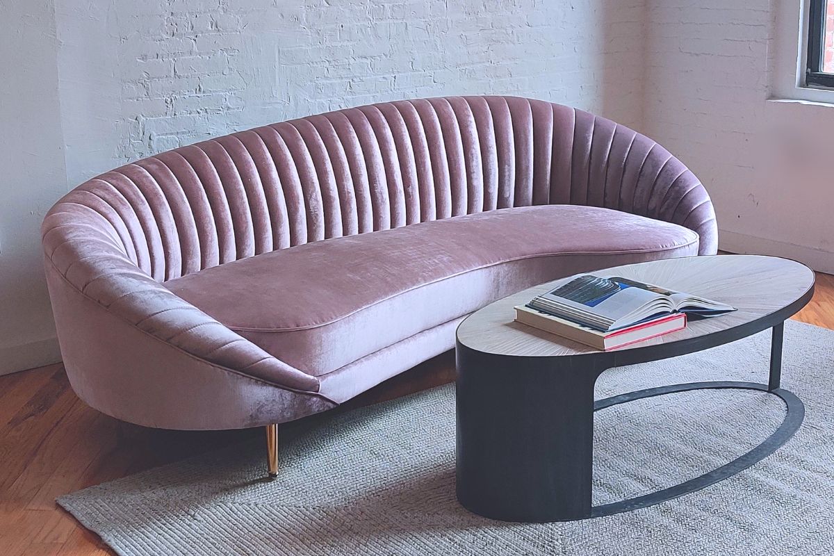 round wood coffee table w curved mid-century modern pink sofa