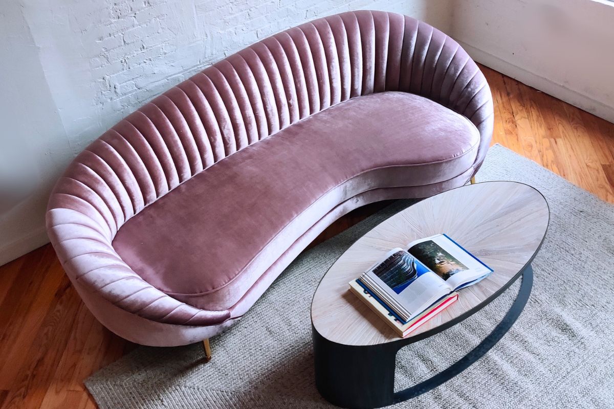curved sofa in pink velvet with unique coffee table
