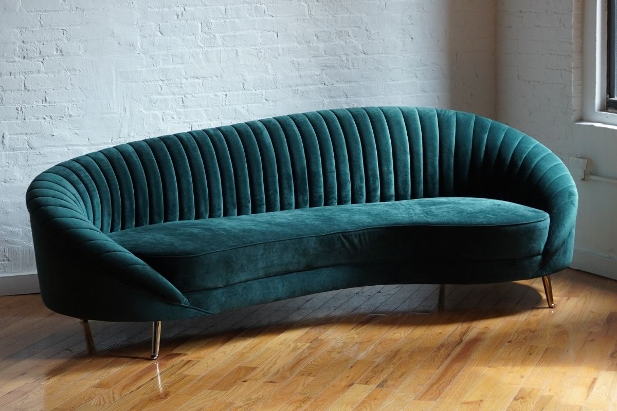 curved modern sofa in green velvet