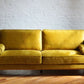 comfortable midcentury modern sofa in retro yellow velvet
