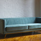 Stately seamfoam teal velvet ribbed couch with gold legs, product image angled view