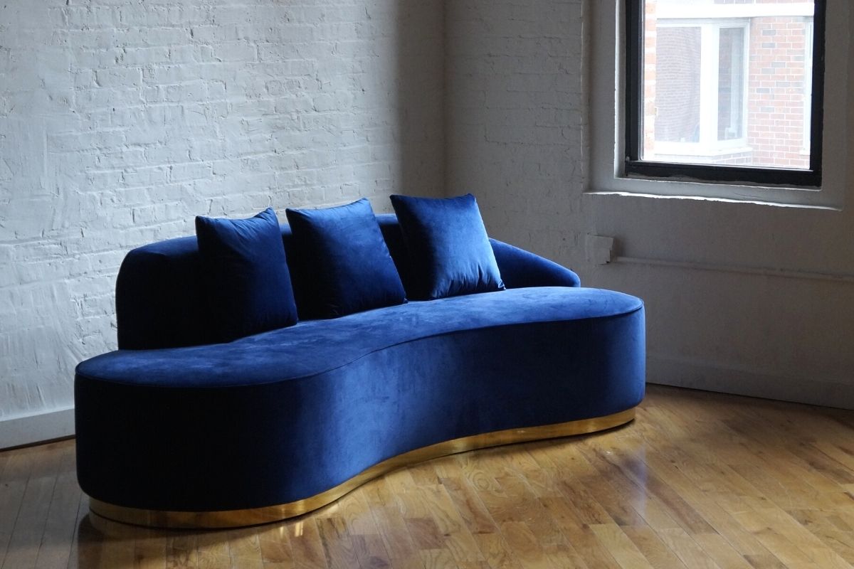 Infinity royal blue sofa with gold base angled view, blue velvet sofa with three pillows product image 