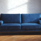 Introspect Royal blue velvet couch with matching bolsters and brass feet forward view, modern couch, mid-century modern couch product image