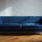 Stately navy blue velvet ribbed couch with gold legs, product image front view