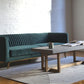 Stately green velvet couch with beam coffee table, modern couch, mid-century modern couch staged image