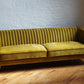 stately three seater sofa in golden olive yellow velvet with brass finish legs